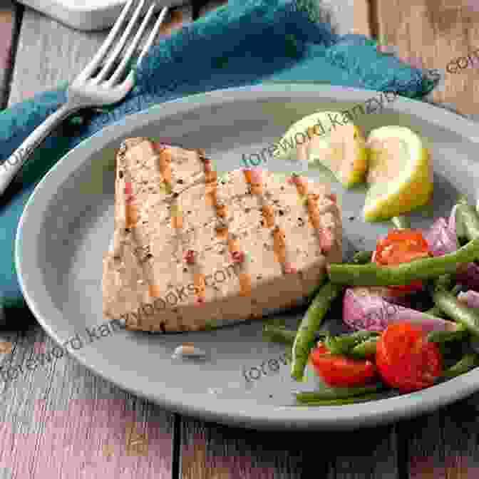 A Close Up Of A Cooked Tuna Steak, Drizzled With Olive Oil And Garnished With Herbs. The Wild Tuna Dinner: Easy Meals To Put Tuna Back On Your Dinner Plate